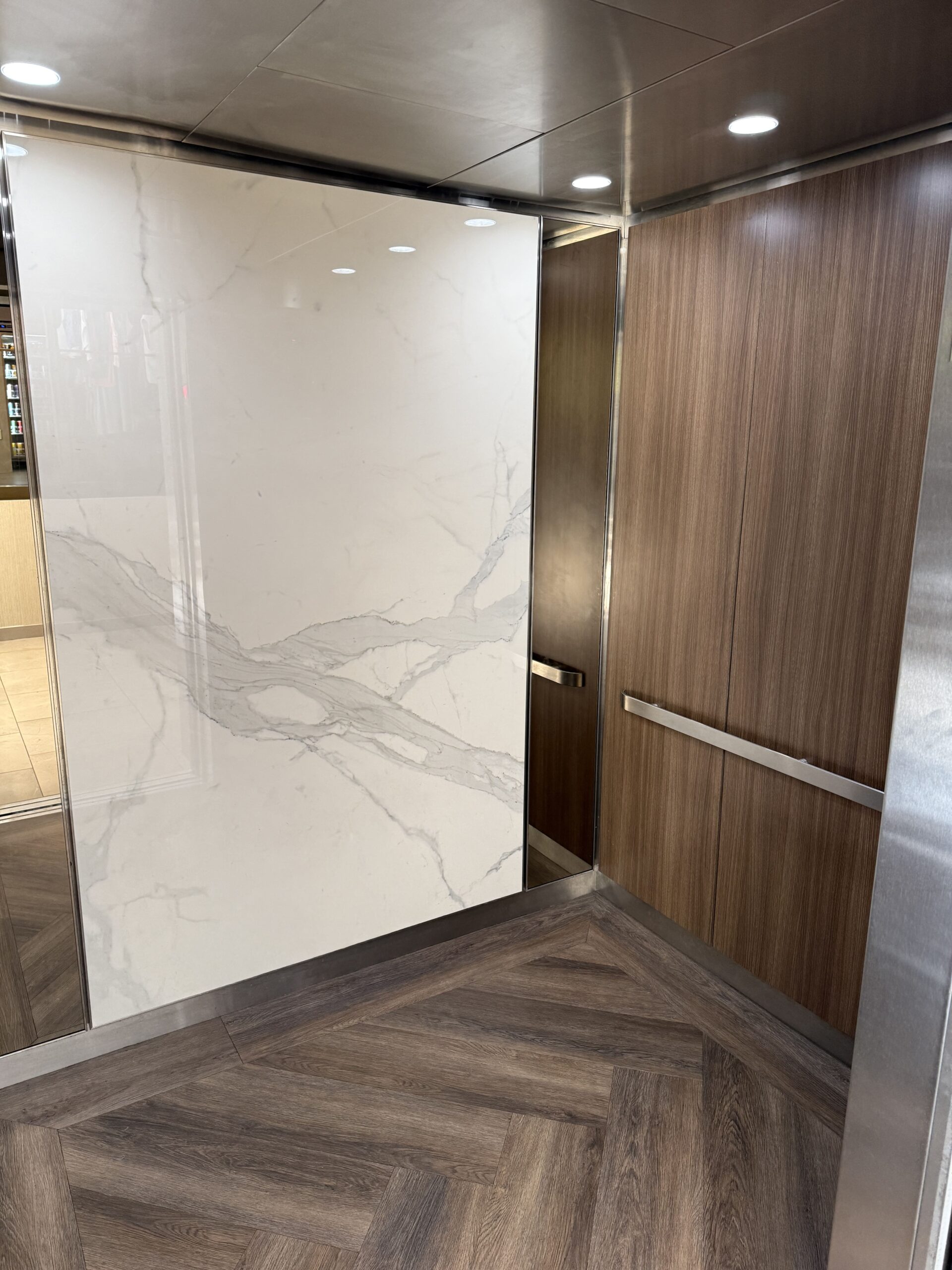 Before elevator interior upgrade showing worn metallic surfaces