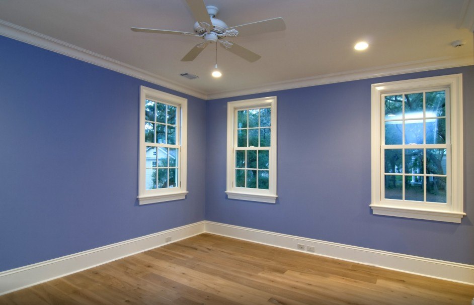 Freshly painted room with purple walls and white-trimmed windows