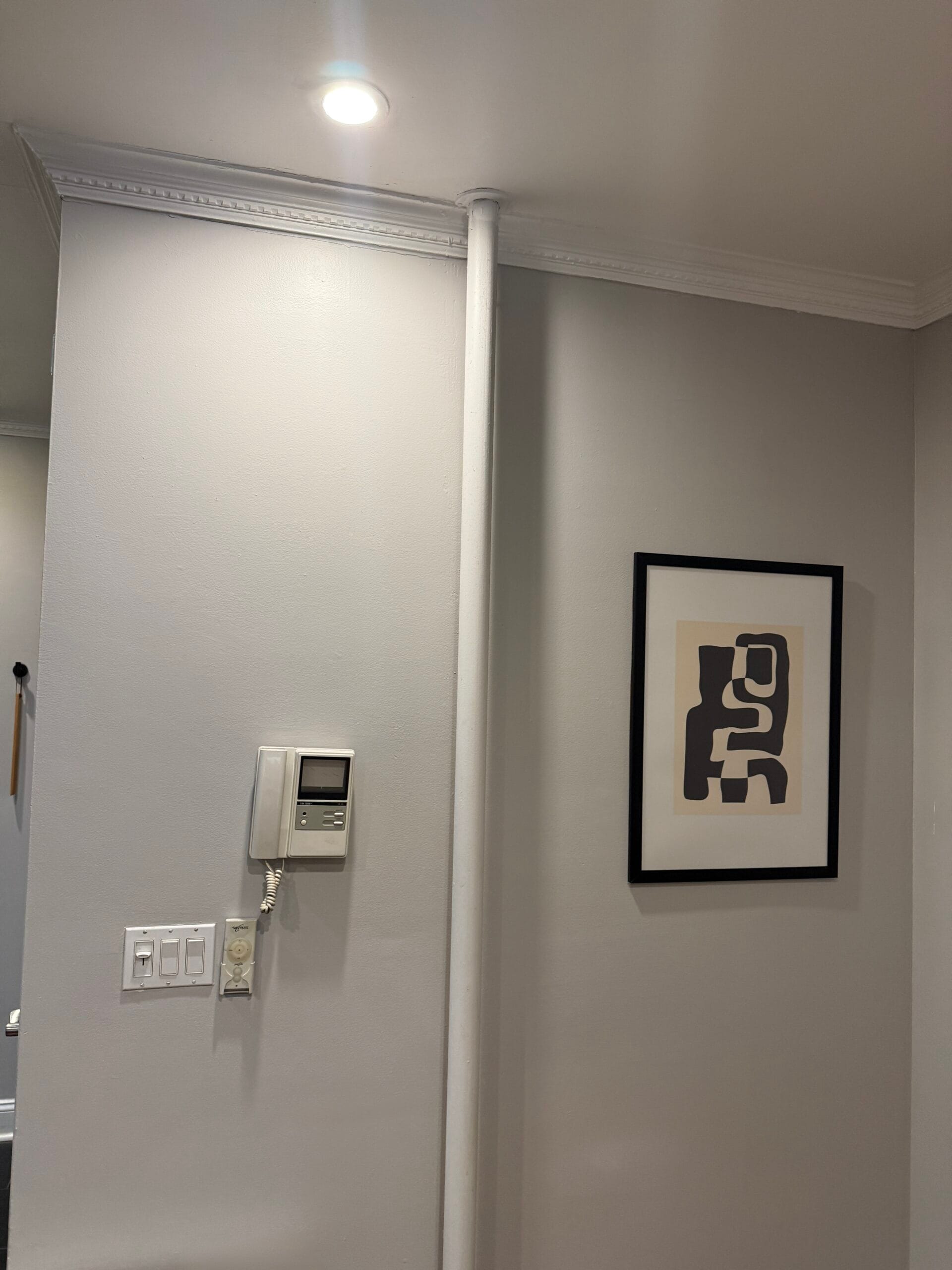 Interior painting in progress - accent wall with blue tape protection in Midtown East apartment turnover